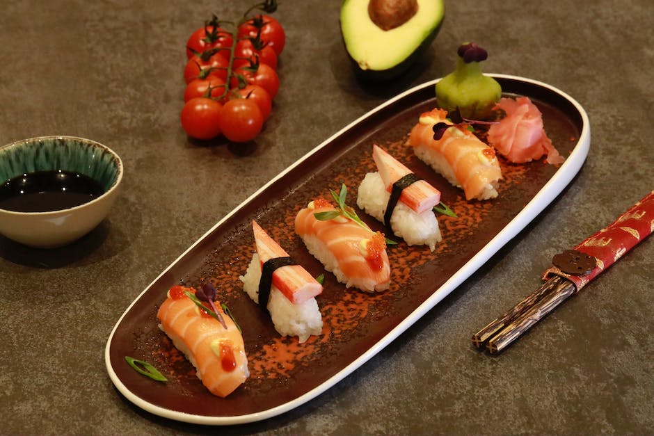 Sushi de lujo con nigiri ingeniosamente cortado, sashimi, exquisitos panecillos, salsa nikiri y adornos de pan de oro.