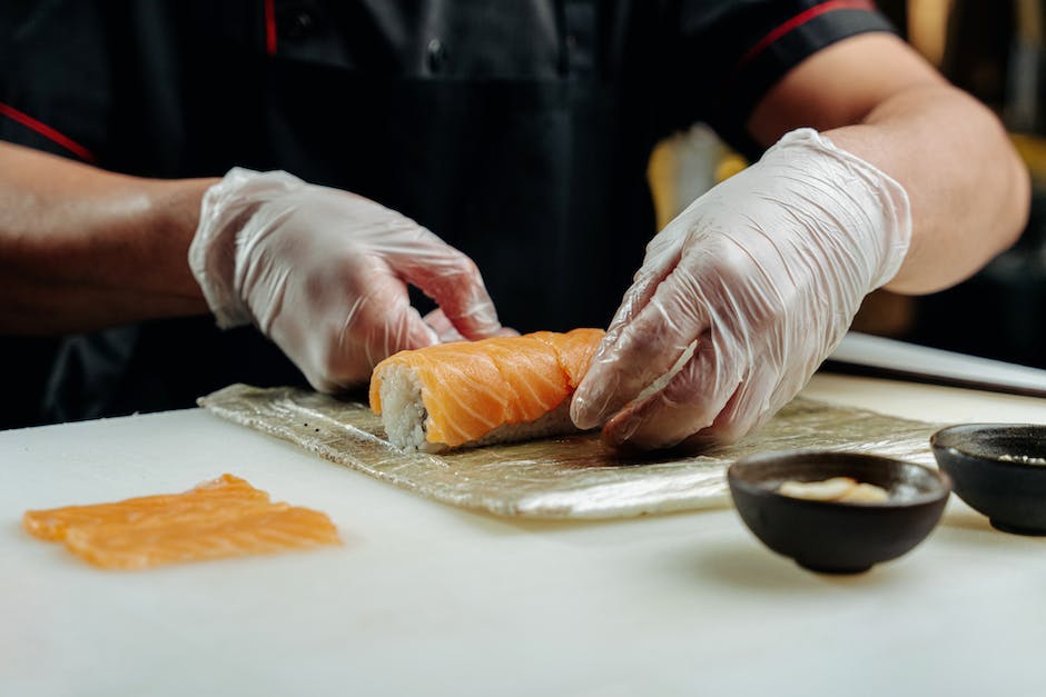 A picture of a sushi chef expertly forming a sushi roll