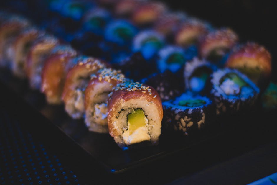 Un hermoso plato de sushi con una variedad de panecillos, nigiri y sashimi.