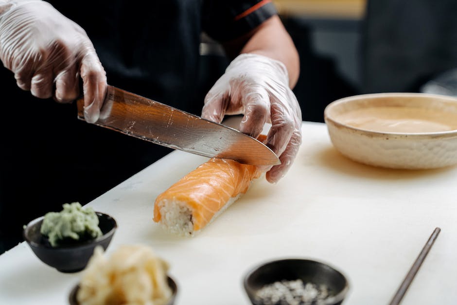 A high-quality sushi knife on a cutting board, ready to cut sushi.